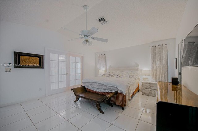 tiled bedroom featuring french doors, ceiling fan, a textured ceiling, and vaulted ceiling