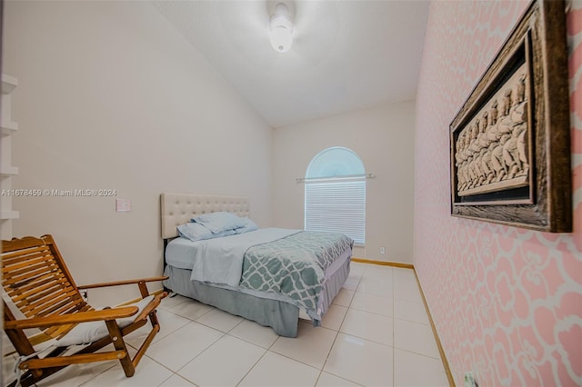 tiled bedroom featuring vaulted ceiling