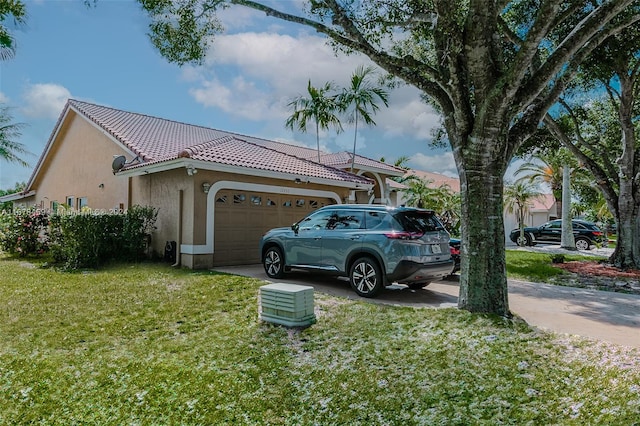 view of property exterior with a yard and a garage