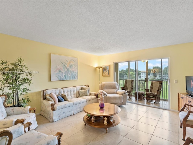 tiled living room featuring a textured ceiling