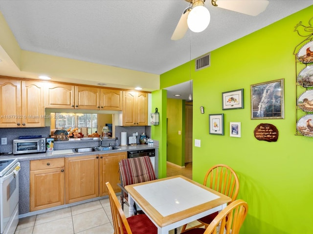 kitchen with ceiling fan, light tile patterned floors, a textured ceiling, white stove, and sink