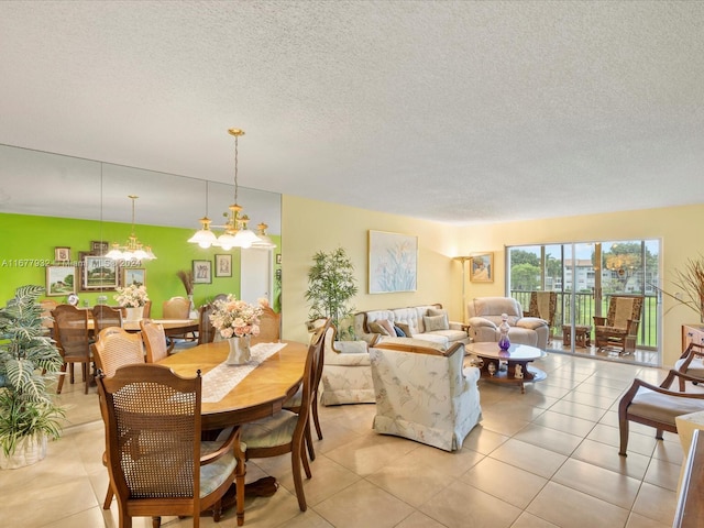 tiled dining area featuring a textured ceiling and a chandelier