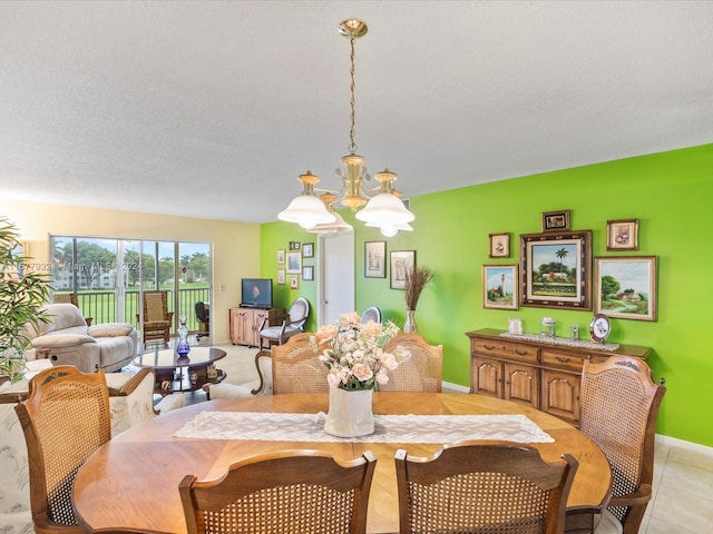 dining room featuring a chandelier, light tile patterned flooring, and a textured ceiling