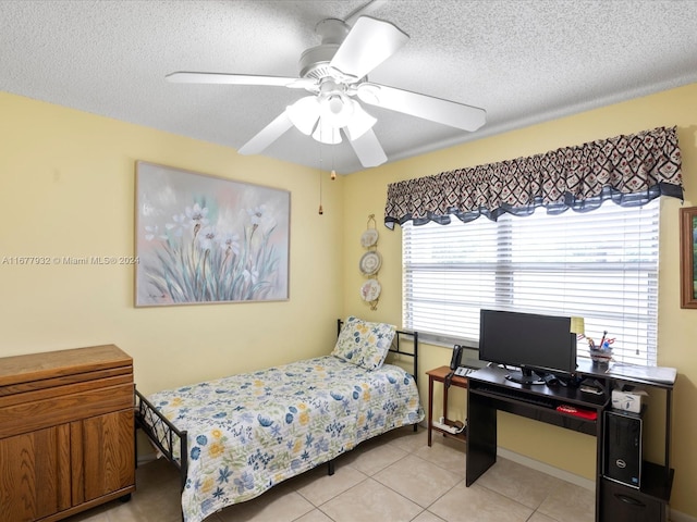 tiled bedroom featuring a textured ceiling and ceiling fan