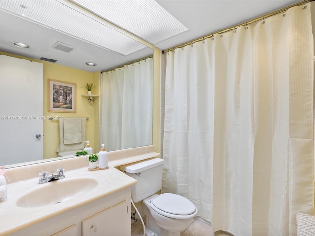 bathroom featuring vanity, curtained shower, toilet, and tile patterned flooring