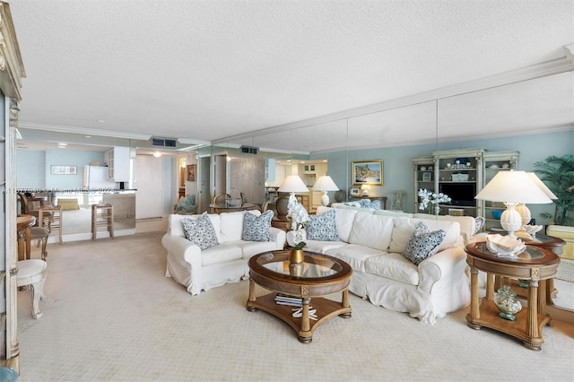 living room featuring light carpet, ornamental molding, and a textured ceiling