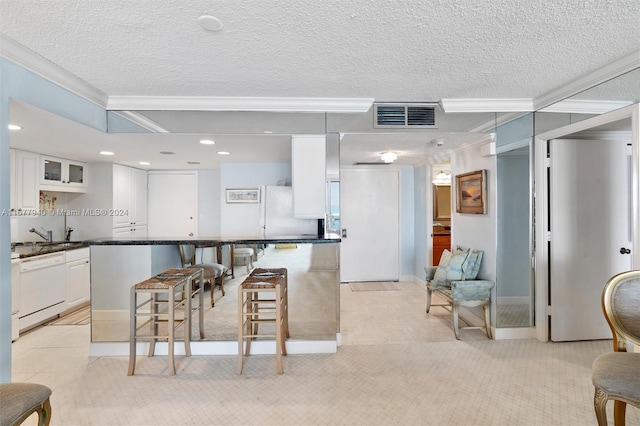 kitchen with white cabinets, light colored carpet, and white appliances