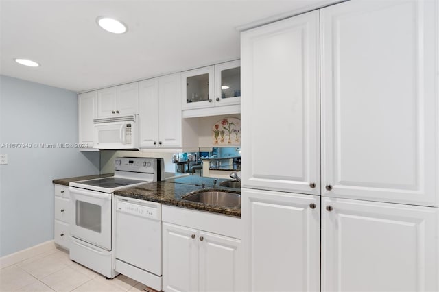 kitchen featuring white appliances, light tile patterned floors, sink, and white cabinets