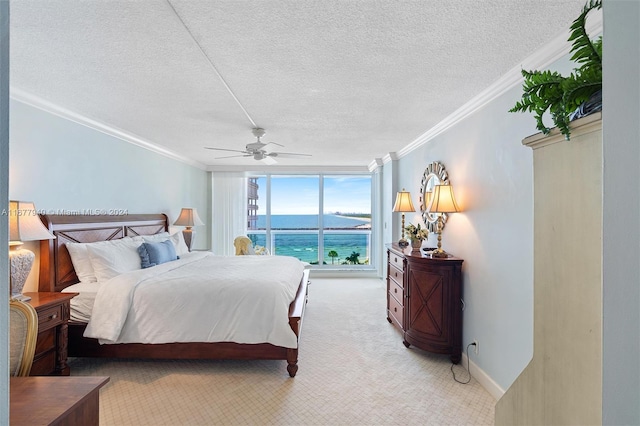 bedroom with crown molding, a water view, a textured ceiling, and ceiling fan