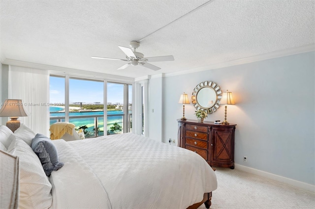 carpeted bedroom with access to exterior, crown molding, a textured ceiling, and ceiling fan