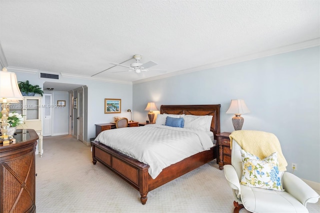 carpeted bedroom with ornamental molding, a textured ceiling, and ceiling fan