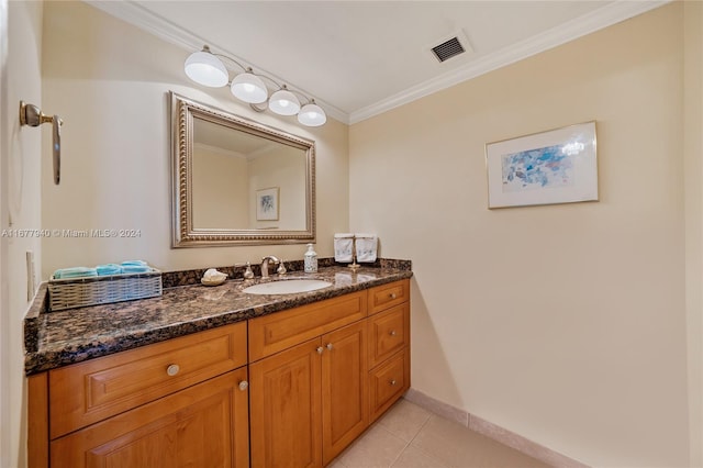 bathroom featuring vanity, crown molding, and tile patterned floors