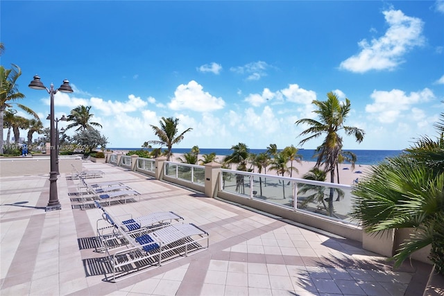 view of patio featuring a balcony and a water view