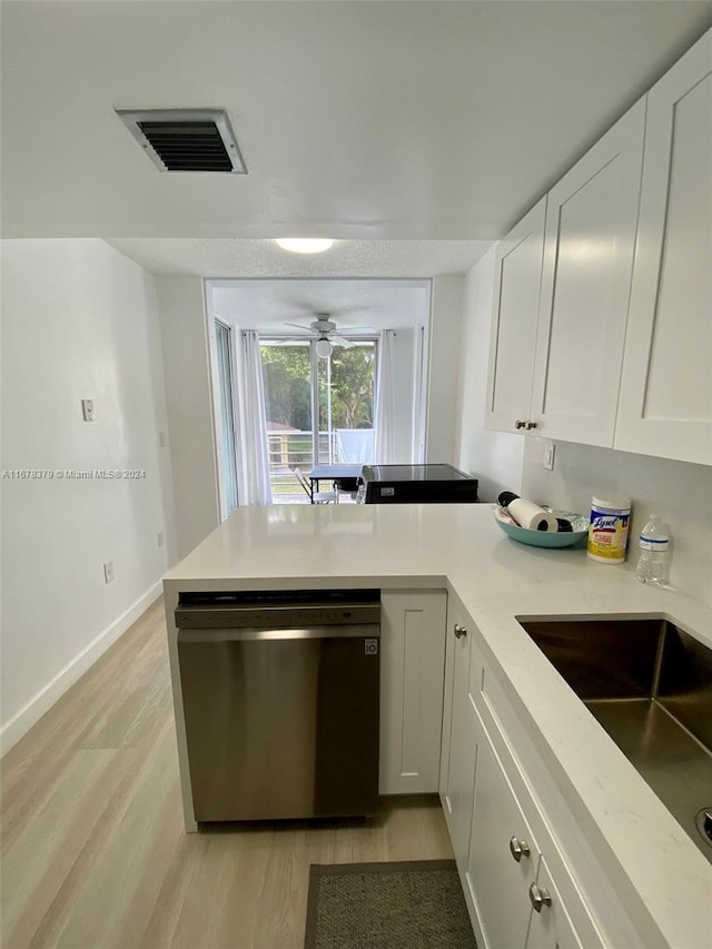 kitchen with ceiling fan, sink, stainless steel dishwasher, light hardwood / wood-style floors, and white cabinets