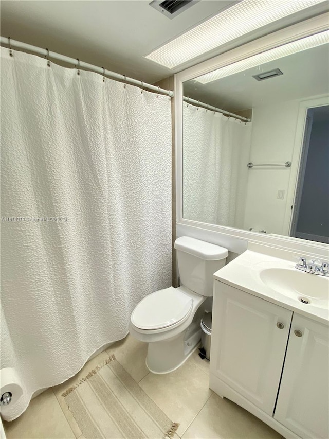 bathroom featuring tile patterned floors, vanity, and toilet