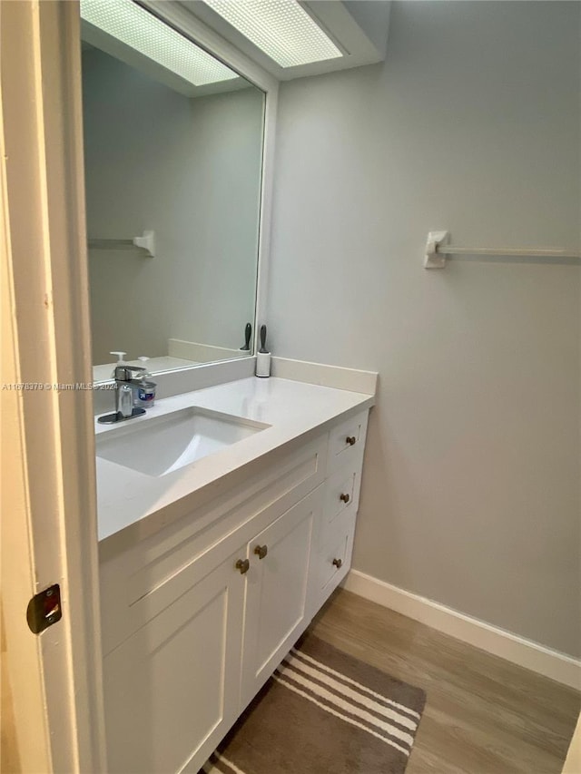 bathroom featuring vanity and hardwood / wood-style flooring