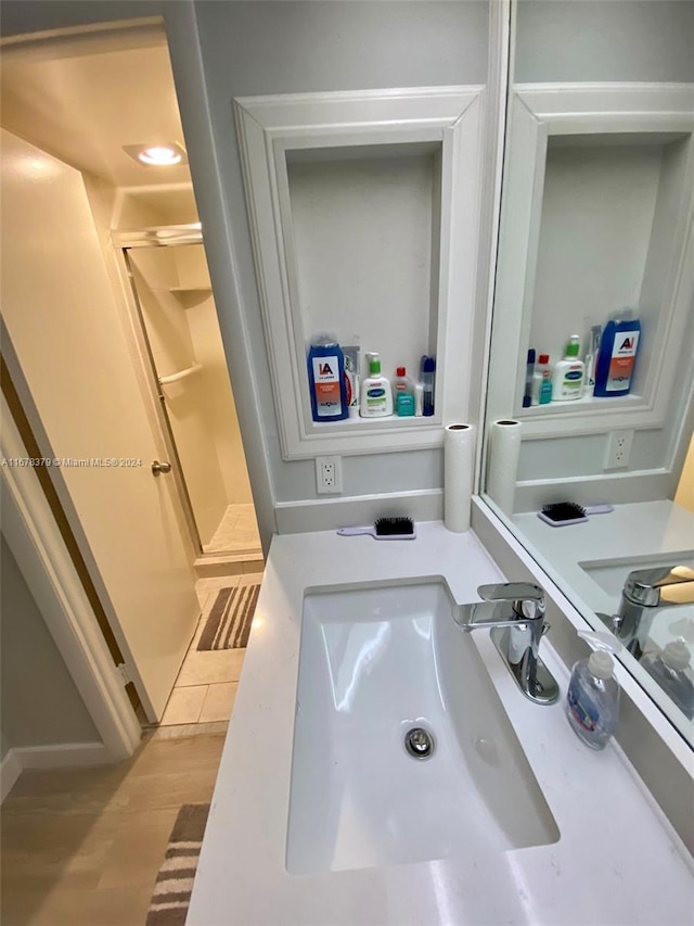 bathroom with hardwood / wood-style floors and sink