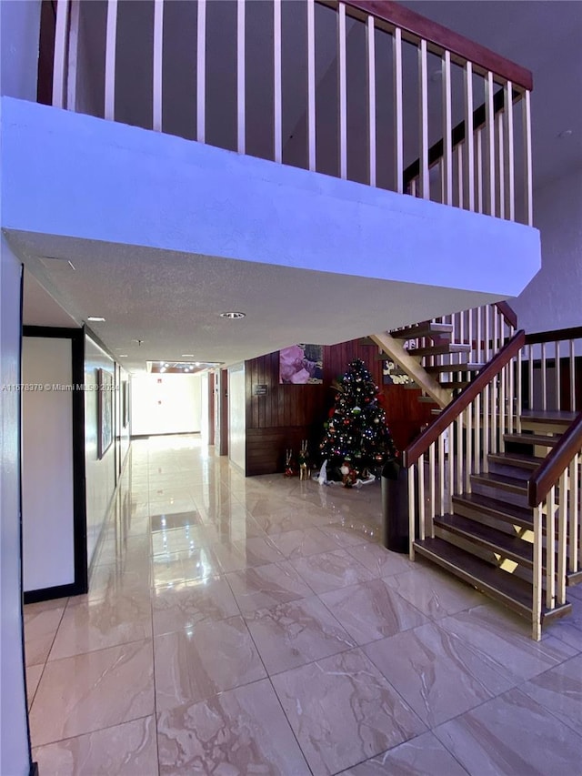 stairway with a textured ceiling