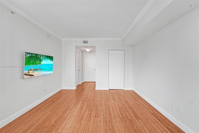 interior space with crown molding and light hardwood / wood-style flooring