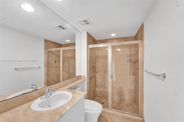 bathroom featuring vanity, toilet, tile patterned flooring, and an enclosed shower