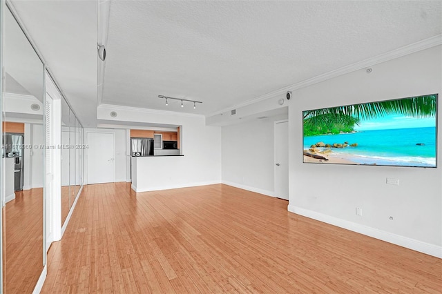 unfurnished living room featuring crown molding, light hardwood / wood-style flooring, and a textured ceiling