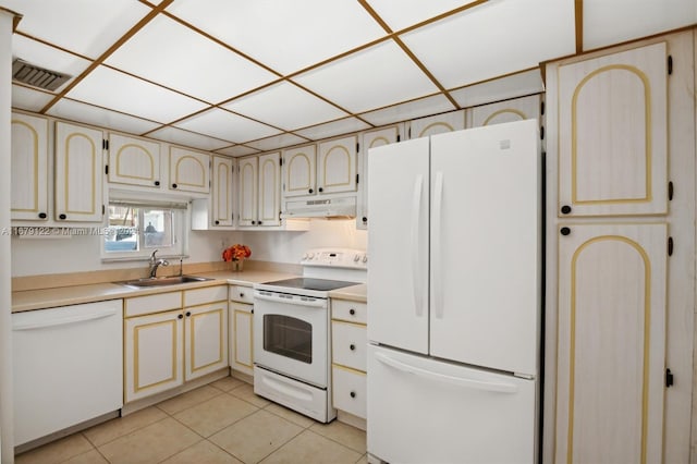 kitchen with white appliances, light tile patterned flooring, and sink