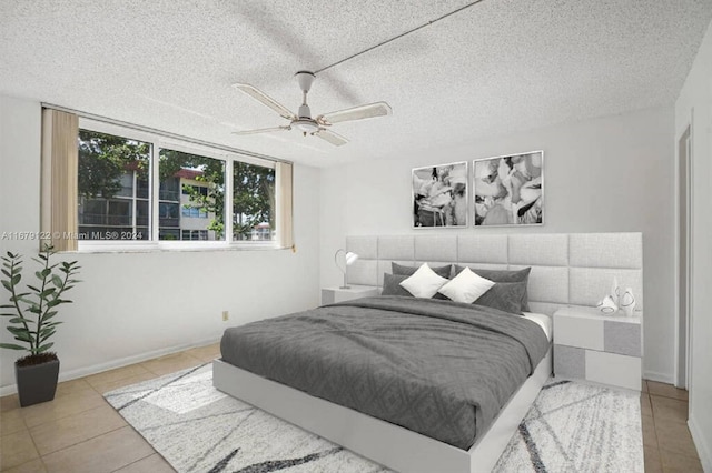 bedroom with light tile patterned flooring, a textured ceiling, and ceiling fan