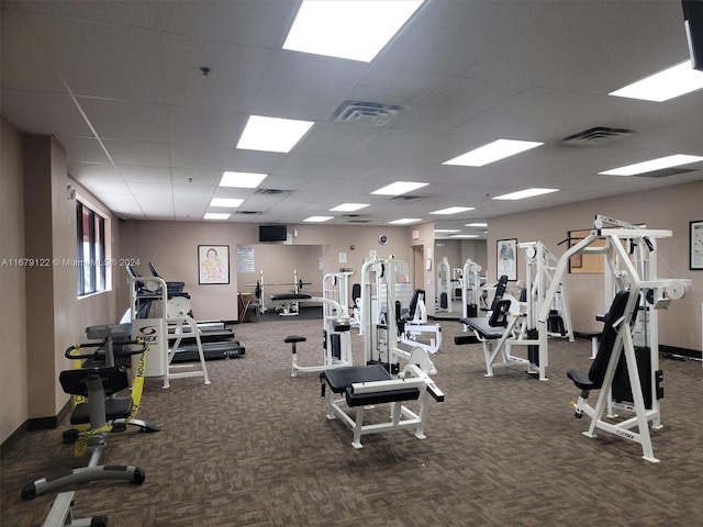 workout area featuring carpet floors and a drop ceiling