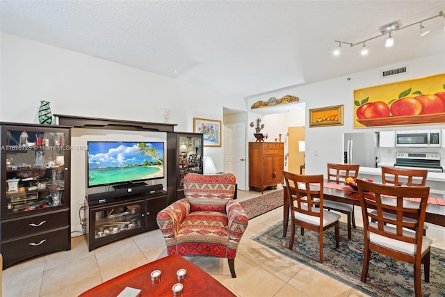 tiled living room featuring a textured ceiling