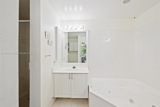 bathroom featuring vanity, tile patterned floors, and separate shower and tub