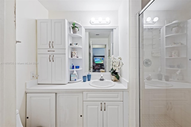 bathroom featuring vanity and an enclosed shower