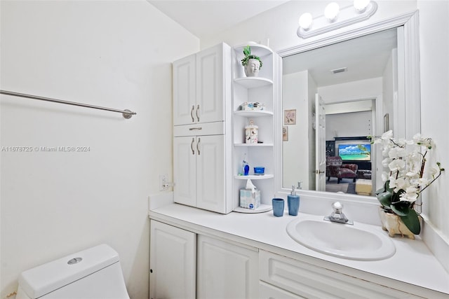 bathroom featuring vanity and toilet