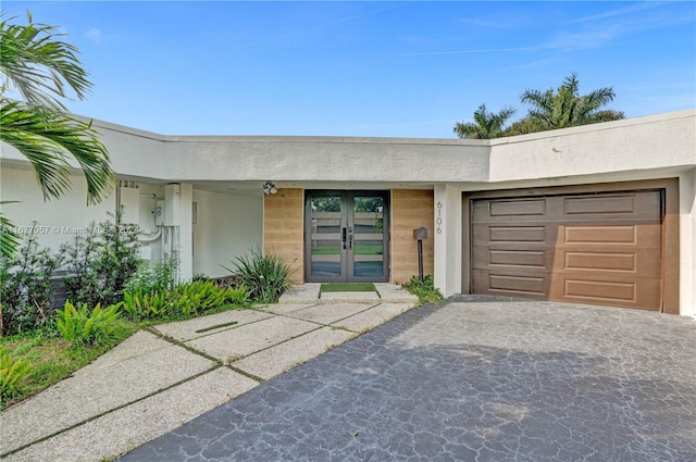 exterior space featuring french doors and a garage