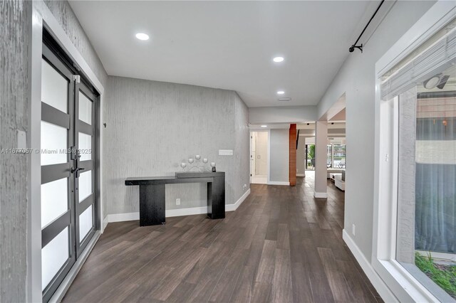 hallway with baseboards, french doors, dark wood-style floors, and recessed lighting