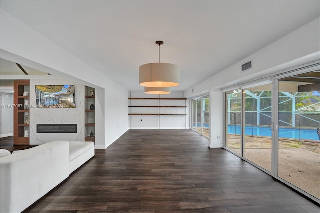 interior space featuring dark wood-type flooring and a high end fireplace