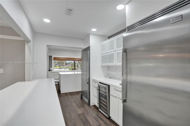 kitchen featuring tasteful backsplash, white cabinetry, high quality fridge, wine cooler, and dark hardwood / wood-style floors