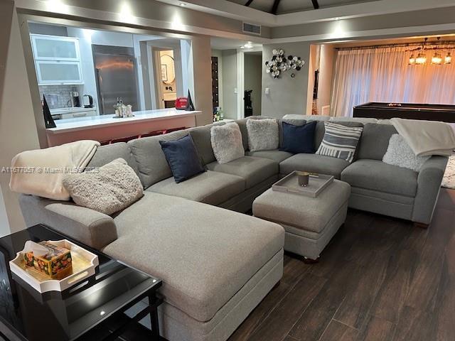 living room featuring visible vents, dark wood-style floors, and billiards