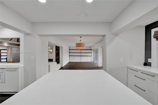 corridor featuring baseboards, recessed lighting, and dark wood finished floors