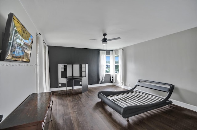 sitting room featuring dark wood-type flooring and ceiling fan