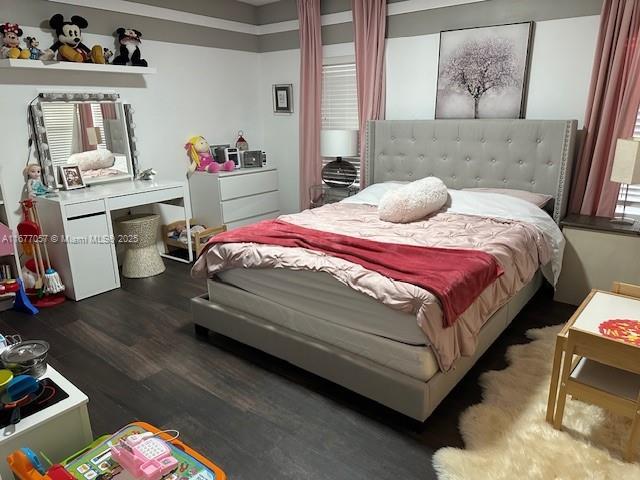 bedroom with wood finished floors