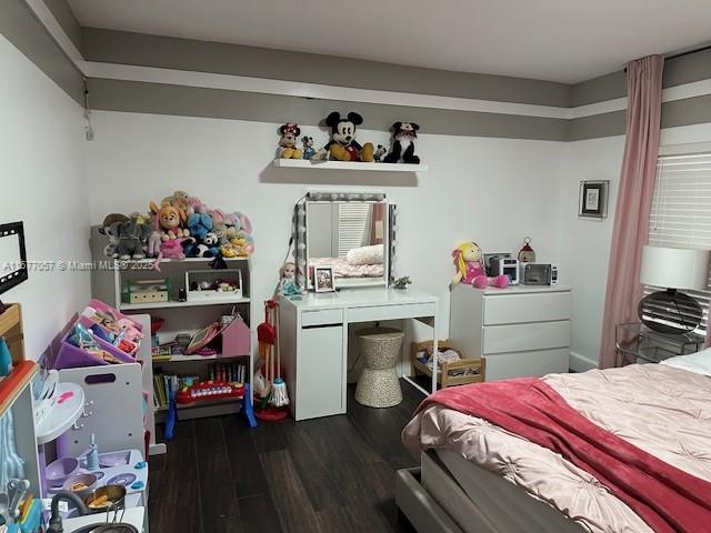 bedroom with dark wood-type flooring