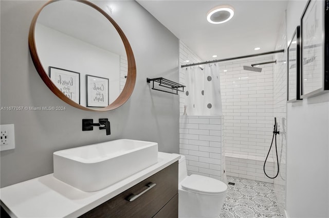 bathroom with vanity, curtained shower, toilet, and tile patterned floors