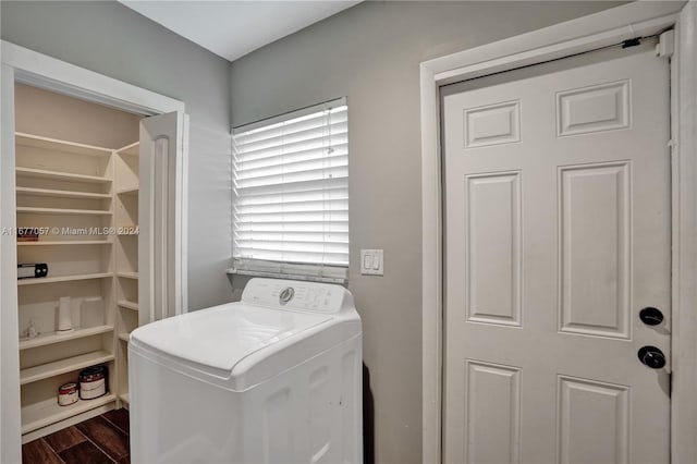 clothes washing area with washer / dryer and dark hardwood / wood-style flooring