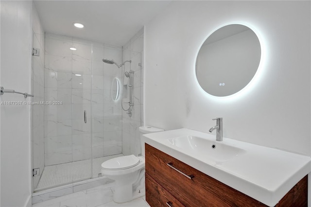 bathroom featuring a shower with door, vanity, and toilet