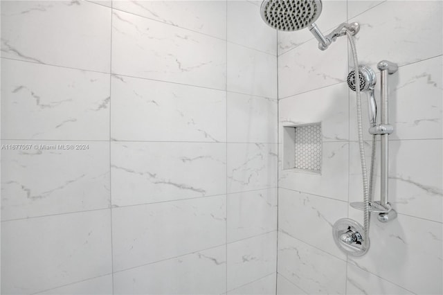 interior details with a tile shower