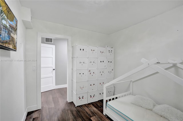 bedroom with dark wood-type flooring