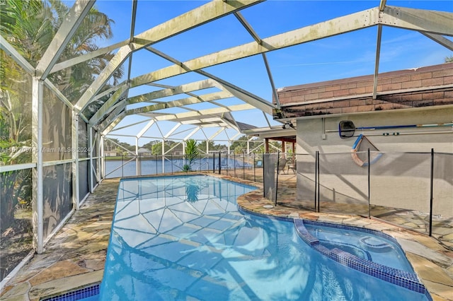 view of swimming pool featuring a patio and a lanai