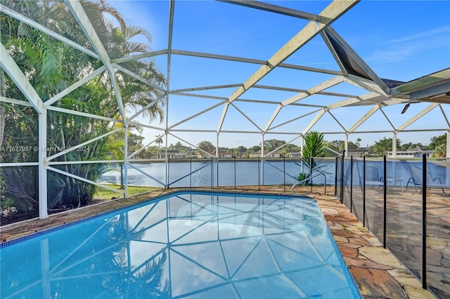 view of pool with a patio area, a water view, and a lanai