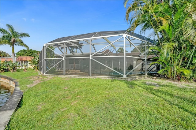 back of property featuring a lanai and a yard