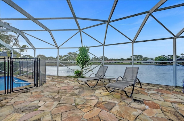 view of patio featuring a lanai, an outdoor pool, and a water view
